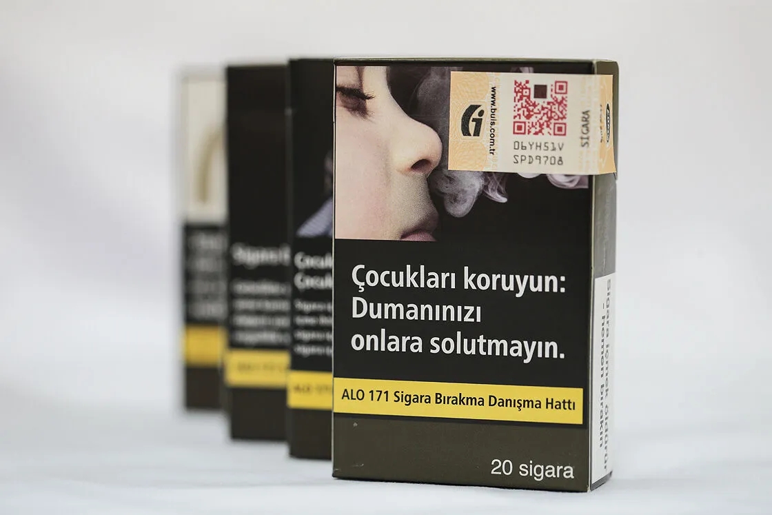 GÖVDE — Türkiye'de satılan standart (düz) sigara paketleri, 'Çocukları koruyun' uyarılı; standart paket bölümünün yanına