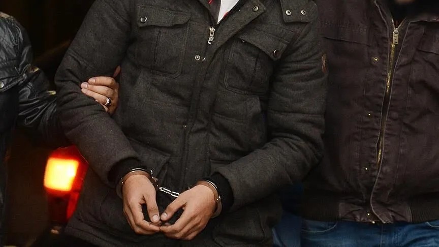 Gözaltına alınan şüpheli kelepçeli hâlde